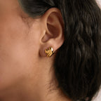 Gold-tone sculptural stud shown on an ear