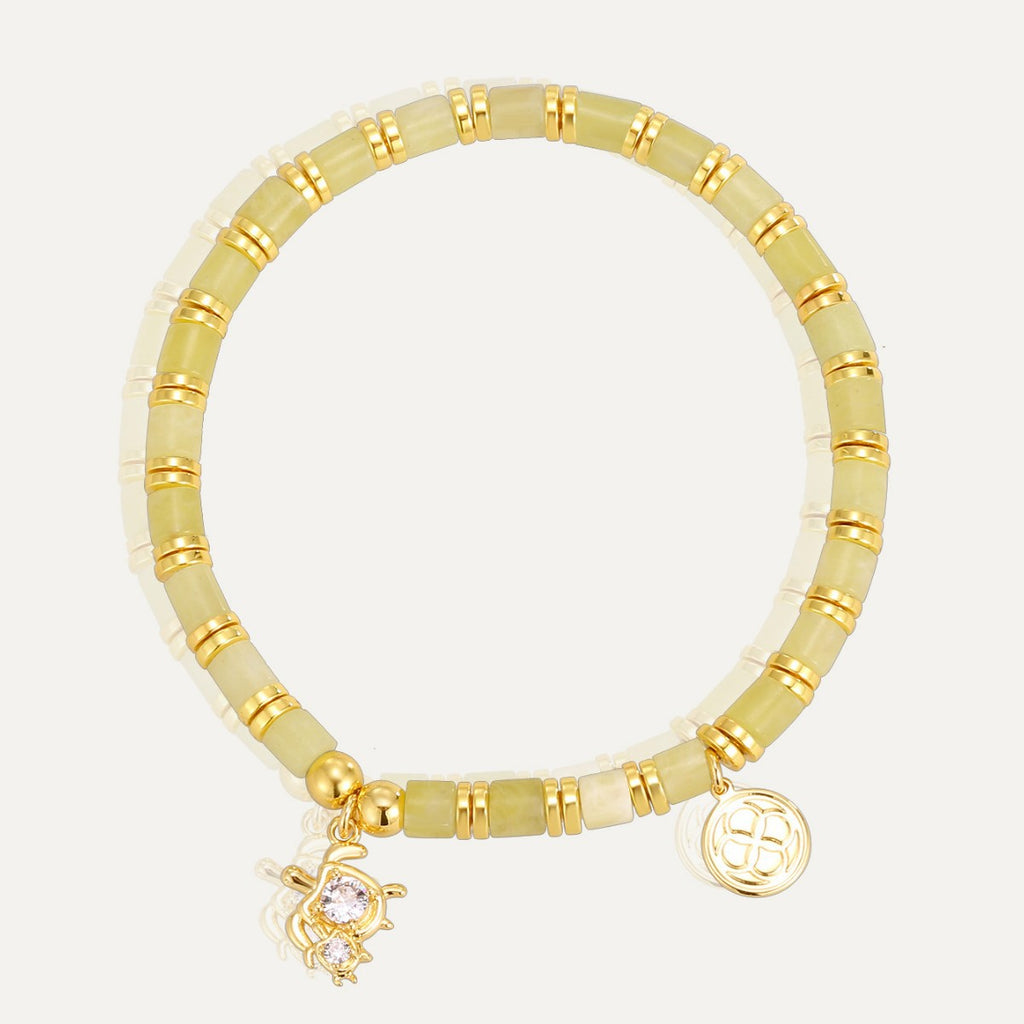 gold plated sea turtle bracelet with pale tube beads on white