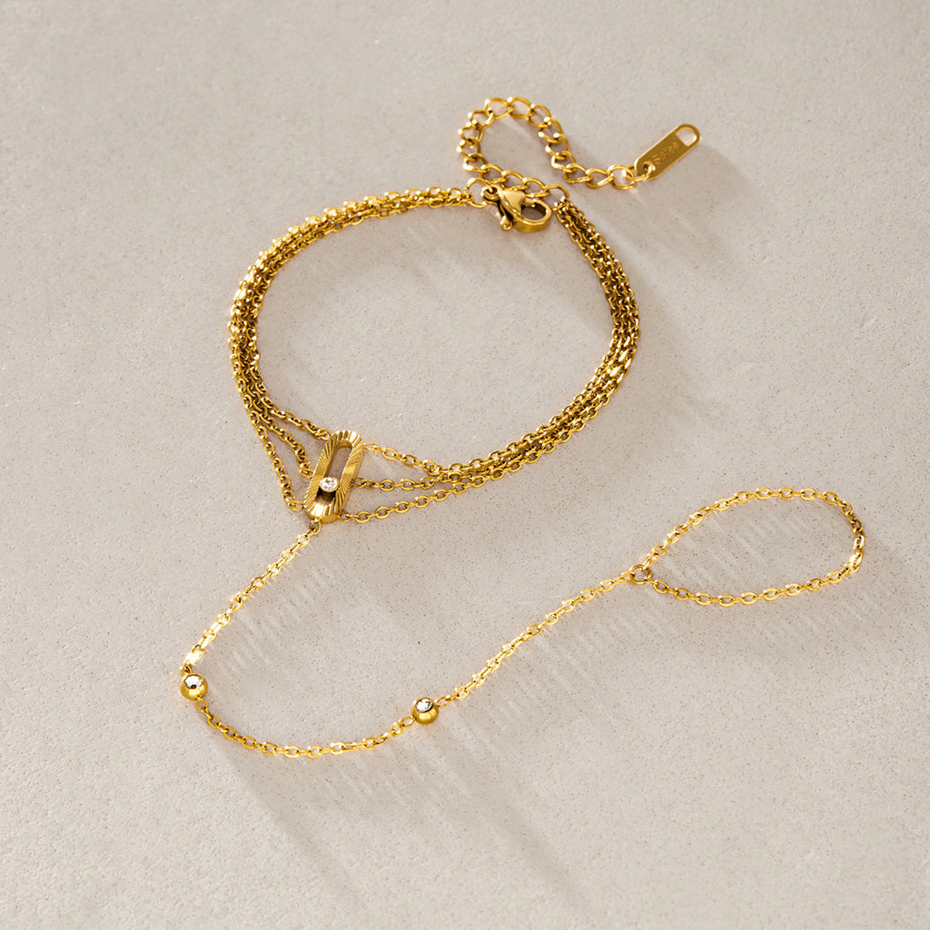 Gold-tone hand bracelet arranged with its finger loop