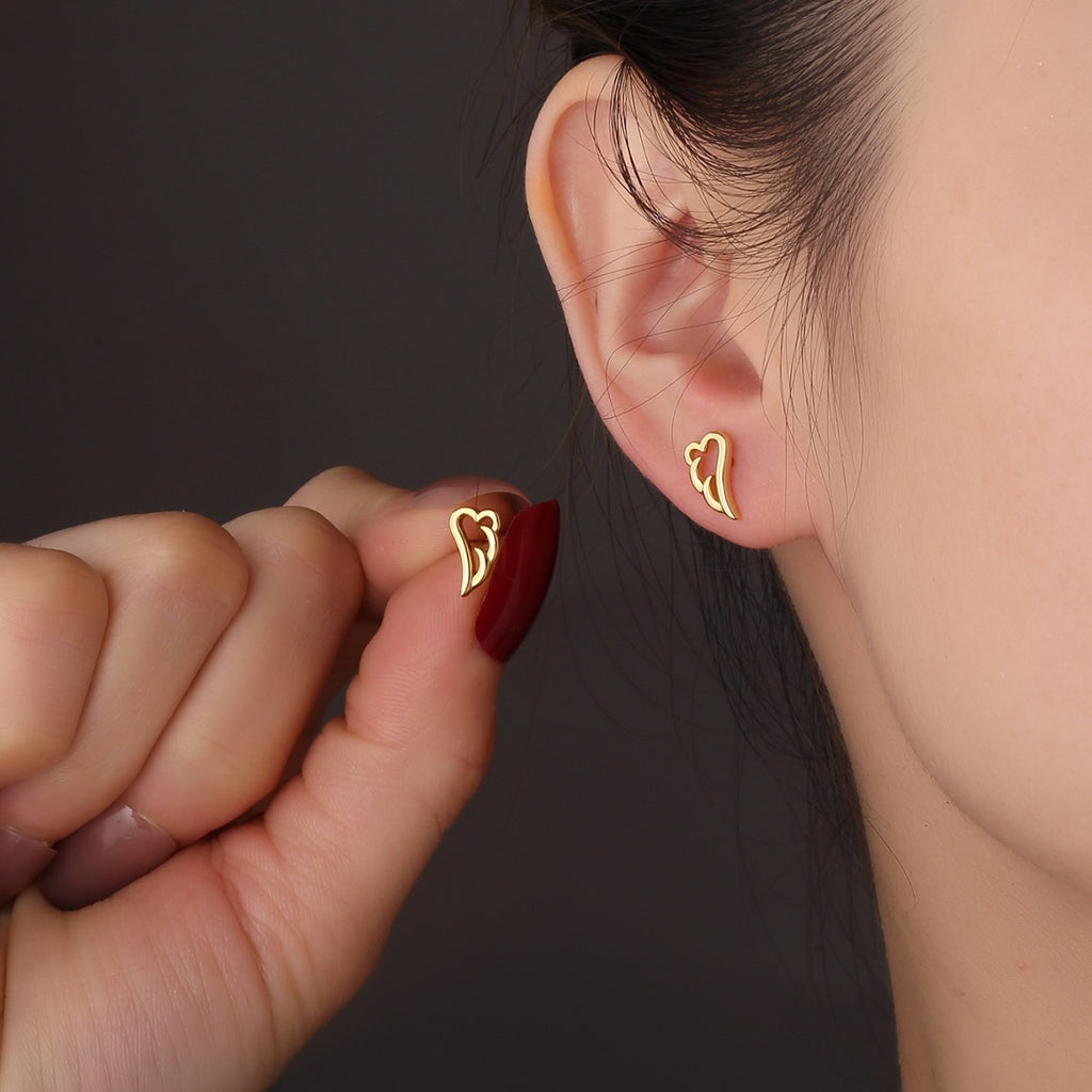 gold plated angel wing ball-back stud earring worn on the ear