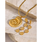 Spiral shell pendant necklace on stone with separate earring references