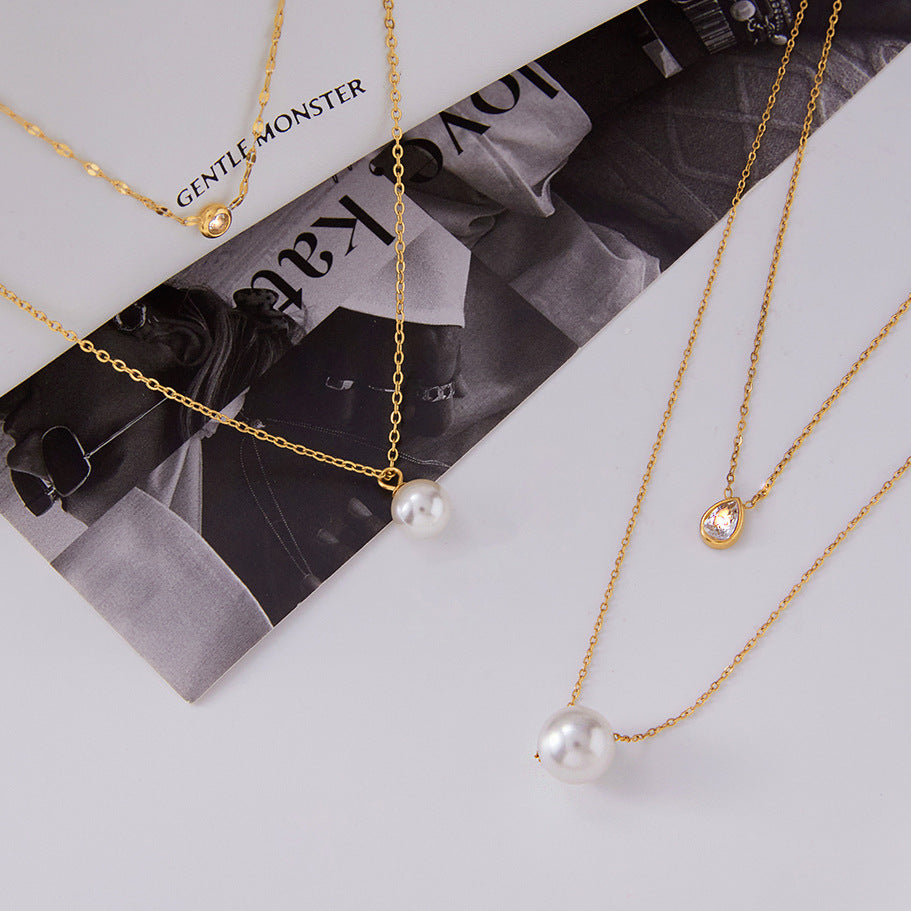 Gold-Tone Clear Accent Stainless Steel Pendant Necklace Collection shown on model