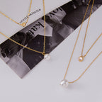 Gold-Tone Clear Accent Stainless Steel Pendant Necklace Collection shown on model