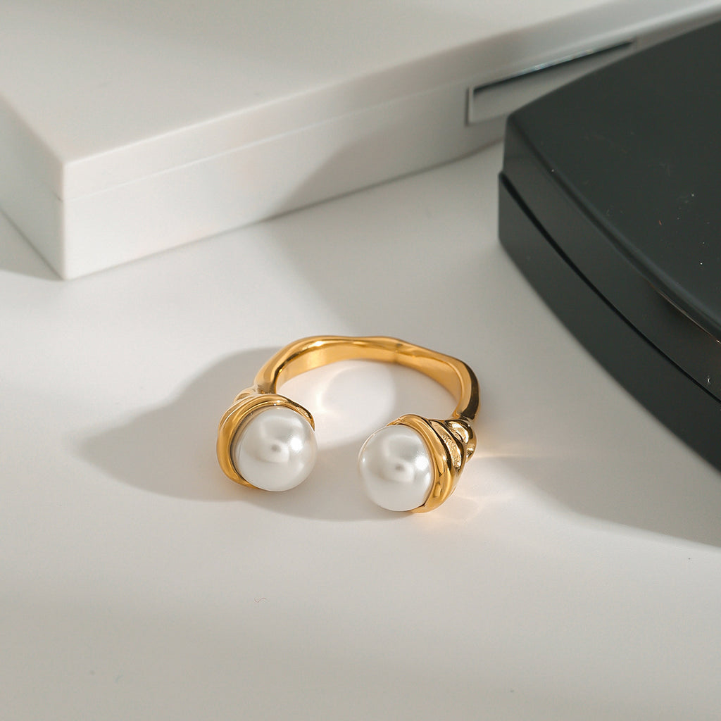 Front view of pearl-look bypass ring on a white surface