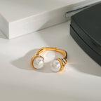 Front view of pearl-look bypass ring on a white surface
