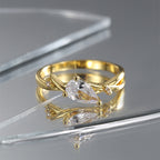gold plated bypass ring with pear-shaped center and two accents