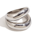 isolated silver-finish stainless steel ring with intersecting curves