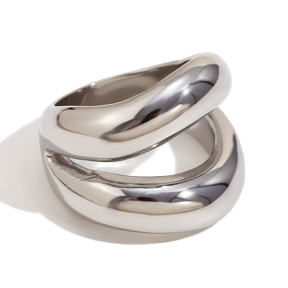isolated silver-finish stainless steel ring with intersecting curves