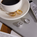 Tapered hoops beside a cup