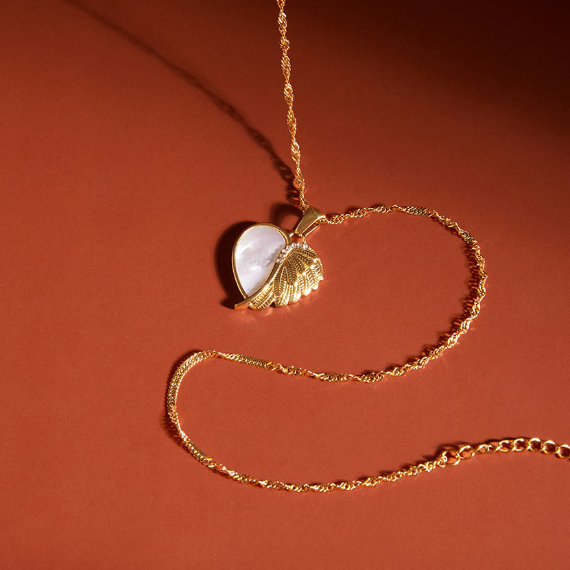 Winged heart pendant with white inlay on a twisted chain
