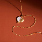 Winged heart pendant with white inlay on a twisted chain