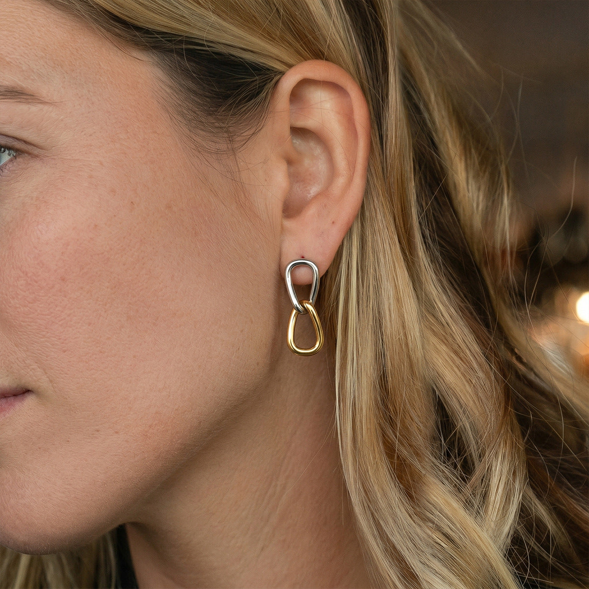 Two tone plain linked drop earring shown on the ear