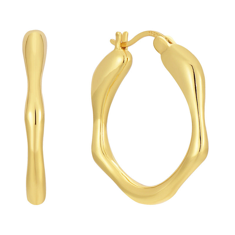 brass wavy oval hoop earrings shown from front and side