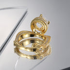 rear view of sculptural cross-over ring and polished brass band