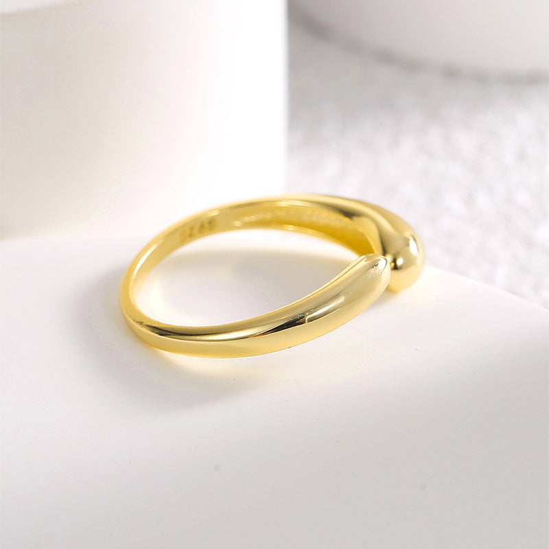 side view of gold plated asymmetric open ring on white