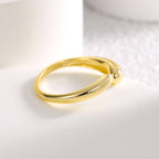 side view of gold plated asymmetric open ring on white