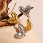 Gold Plated and Silver 316L Stainless Steel Heart Drop Earrings — linked hearts resting on wood