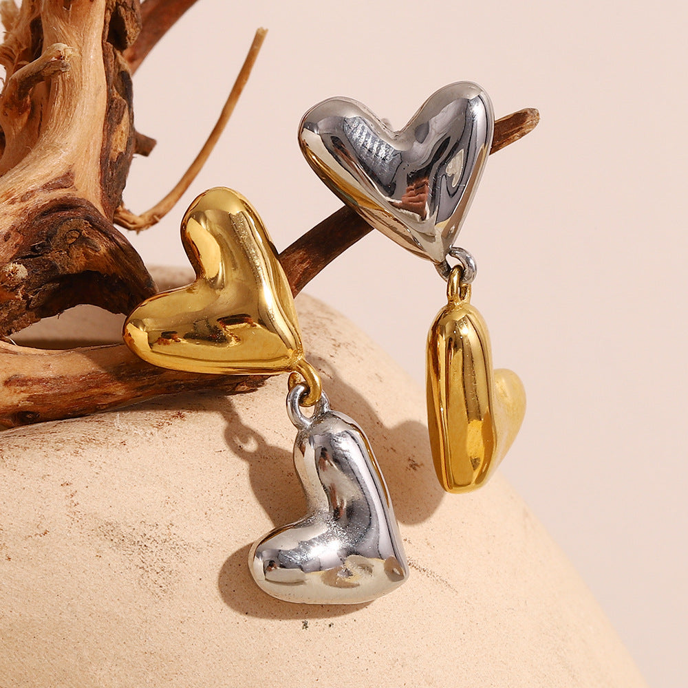 Gold Plated and Silver 316L Stainless Steel Heart Drop Earrings — linked hearts resting on wood