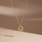Single circle pendant necklace on pale display