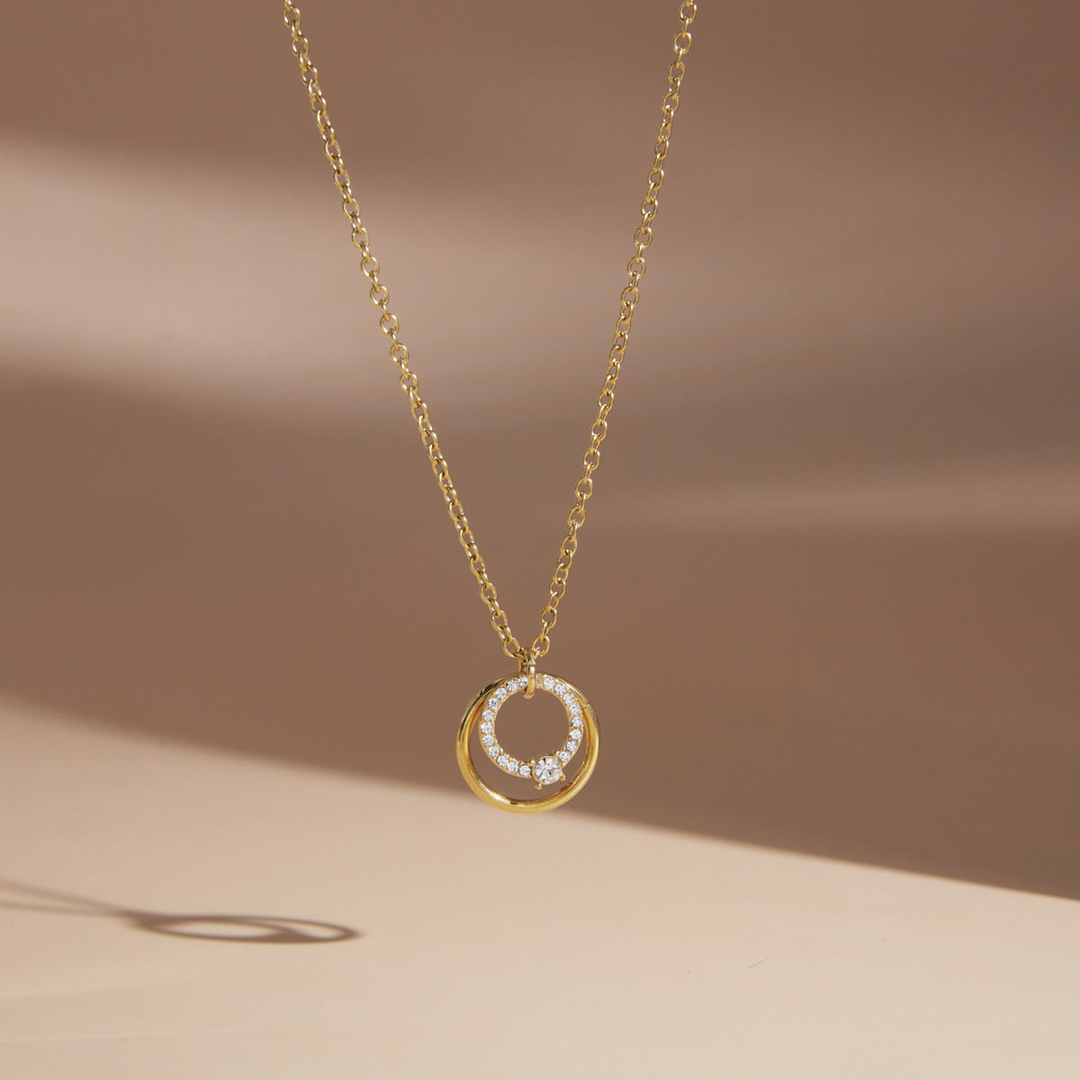 Single circle pendant necklace on pale display