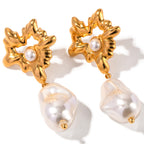 Gold-tone flower earrings with irregular white bead front view