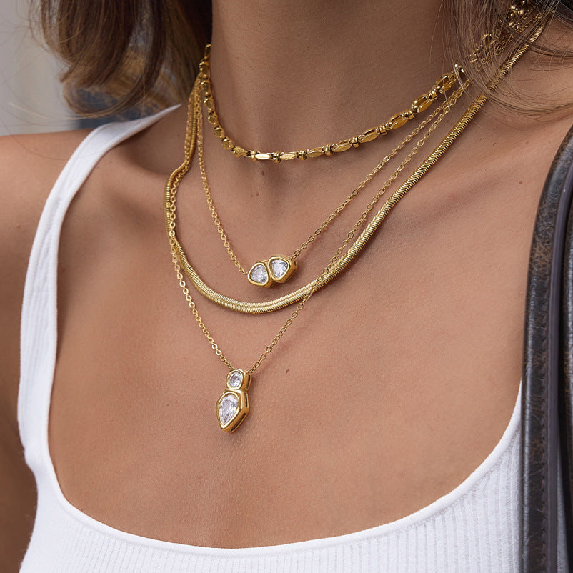 Two clear stone necklaces layered with plain chains