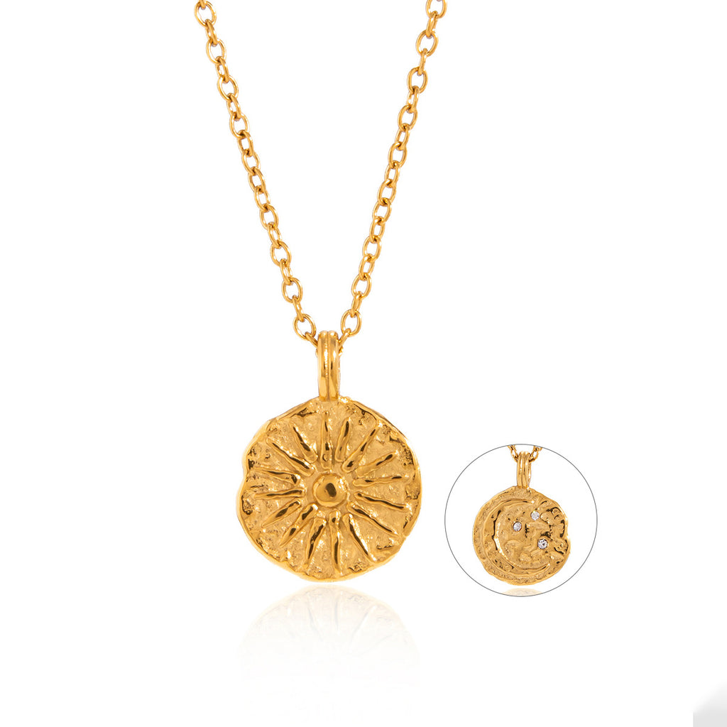 Gold-tone sunburst pendant on white