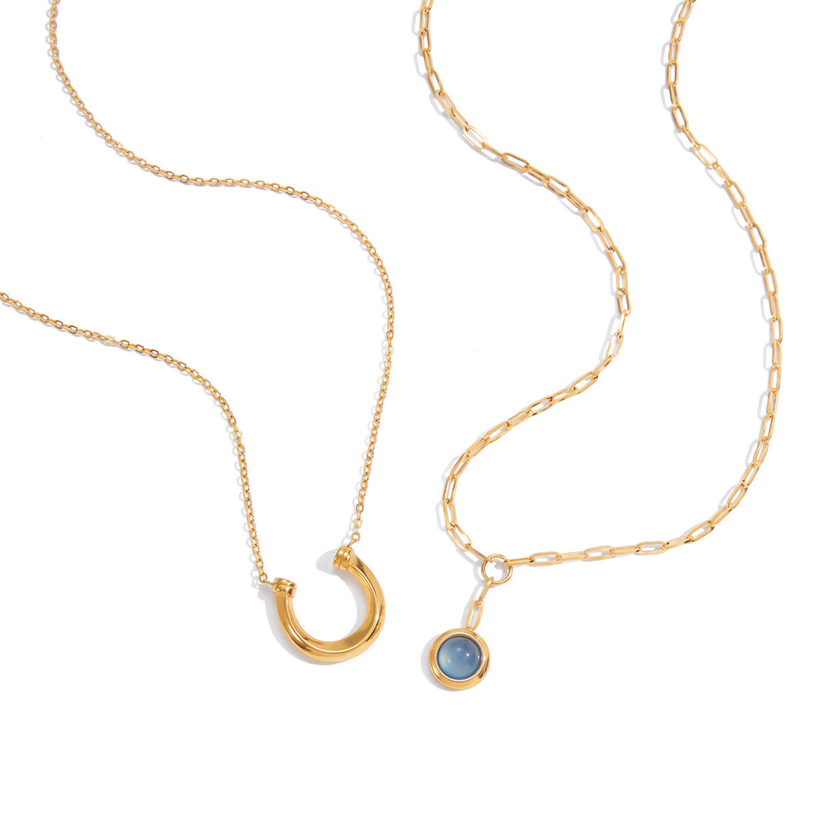 Gold Tone Blue Cabochon Stainless Steel Equestrian Necklaces — close-up of the crescent pendant