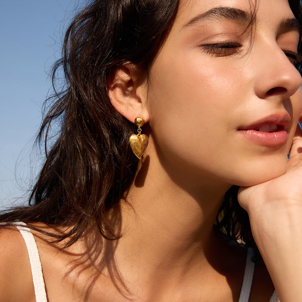Textured heart earrings worn outdoors