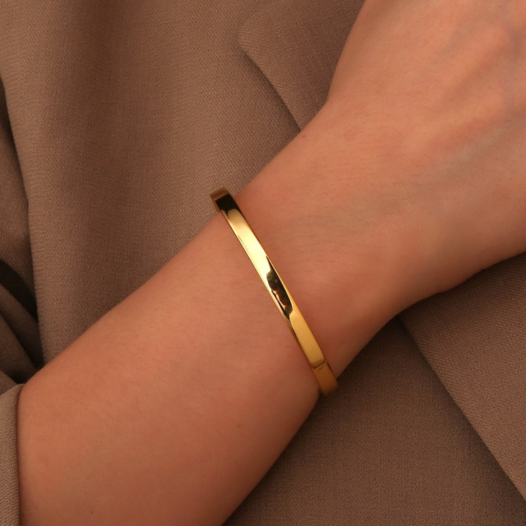 model wearing the slim gold plated open cuff bracelet