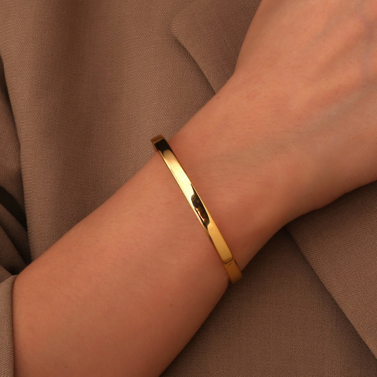 model wearing the slim gold plated open cuff bracelet