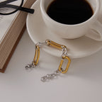 Full bracelet showing clasp and extender beside a cup