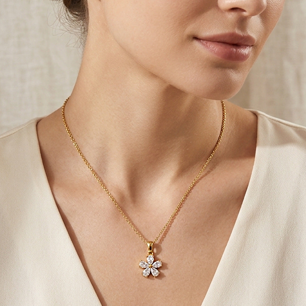 Small flower pendant necklace worn at the neckline