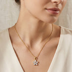 Small flower pendant necklace worn at the neckline