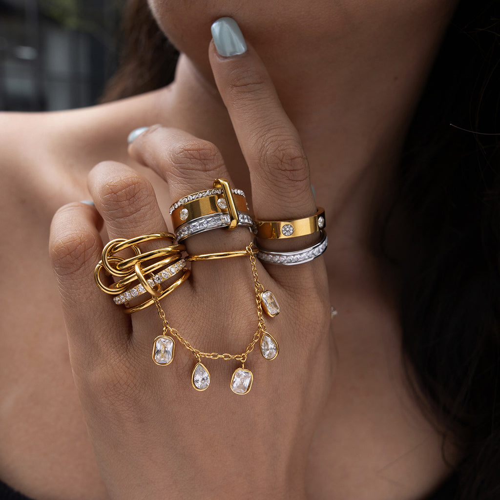 Close-up of linked stainless steel rings on the hand