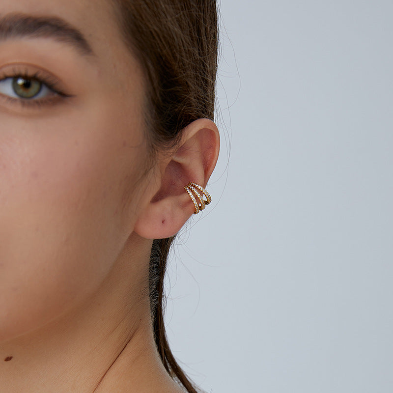 Triple-row clear stone ear cuff shown worn on the ear