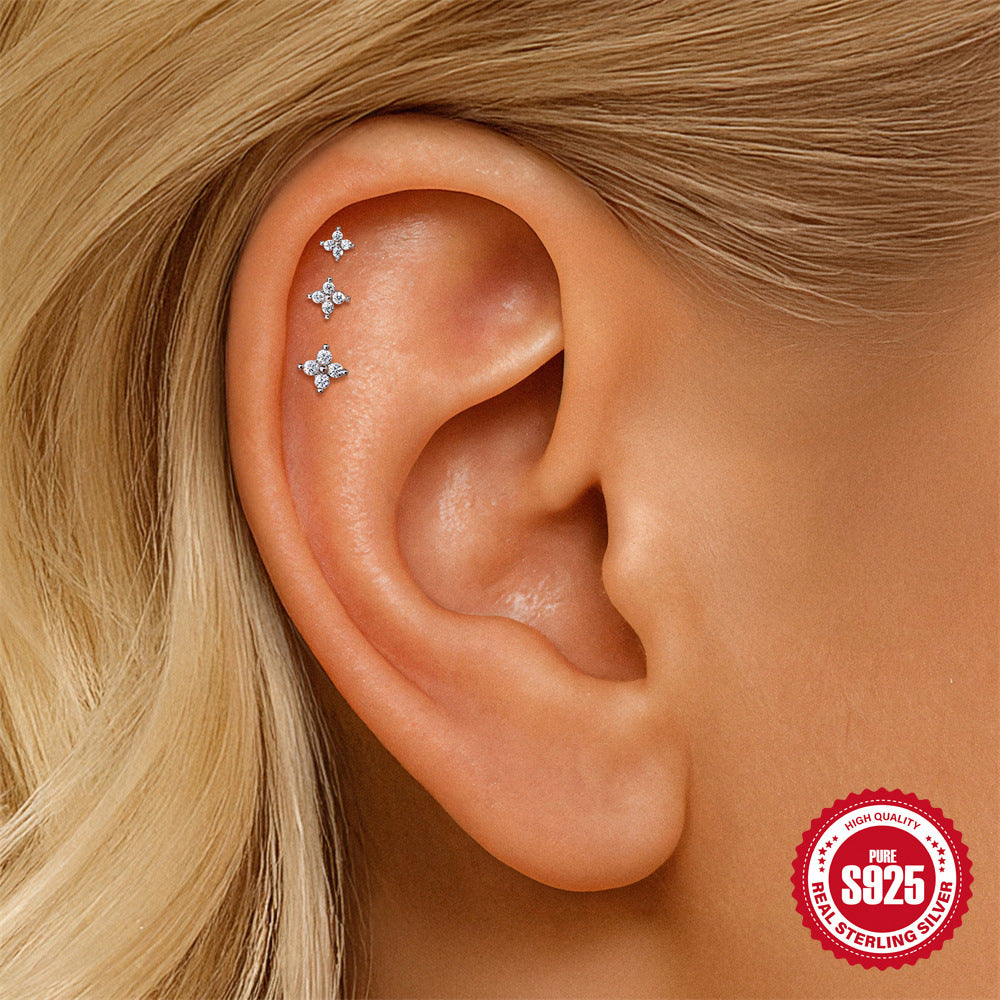 three graduated moissanite star flat-back studs worn along cartilage