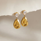 Clear pear studs with polished gold tone teardrop pendants