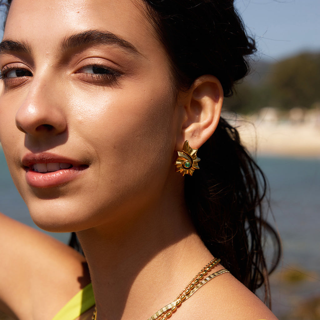 Blue-center spiral shell studs worn outdoors