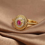 red center stone ring with clear halo on brown satin
