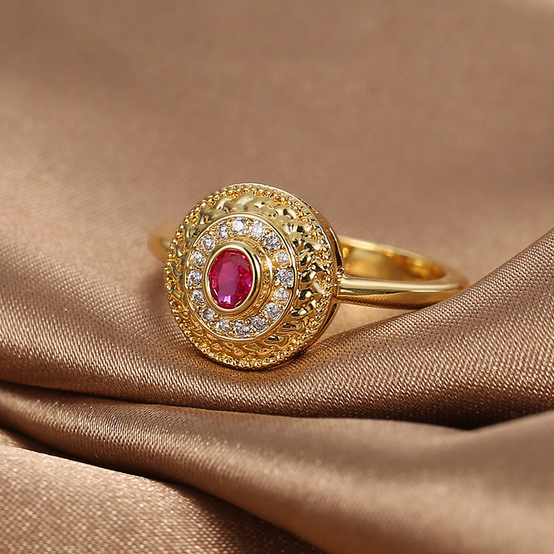 red center stone ring with clear halo on brown satin