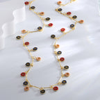 multicolor resin ring charm necklaces arranged on a clear display