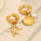 Gold Plated Stainless Steel Starfish and Shell Drop Earrings — worn view
