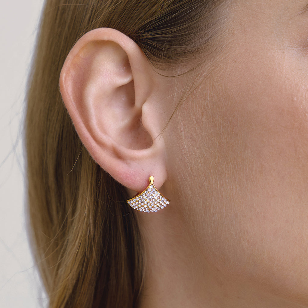 Fan-shaped rhinestone earring worn close-up
