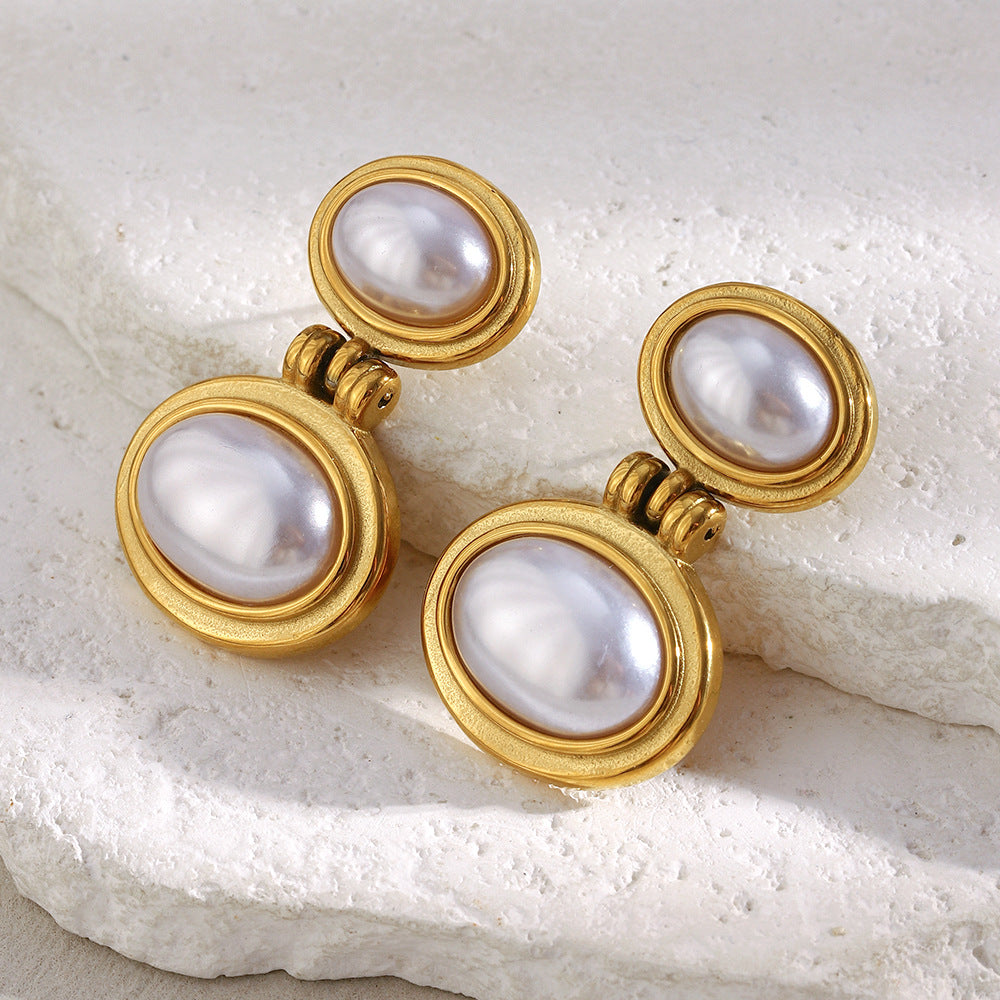 gold plated double imitation pearl drop earrings on white stone