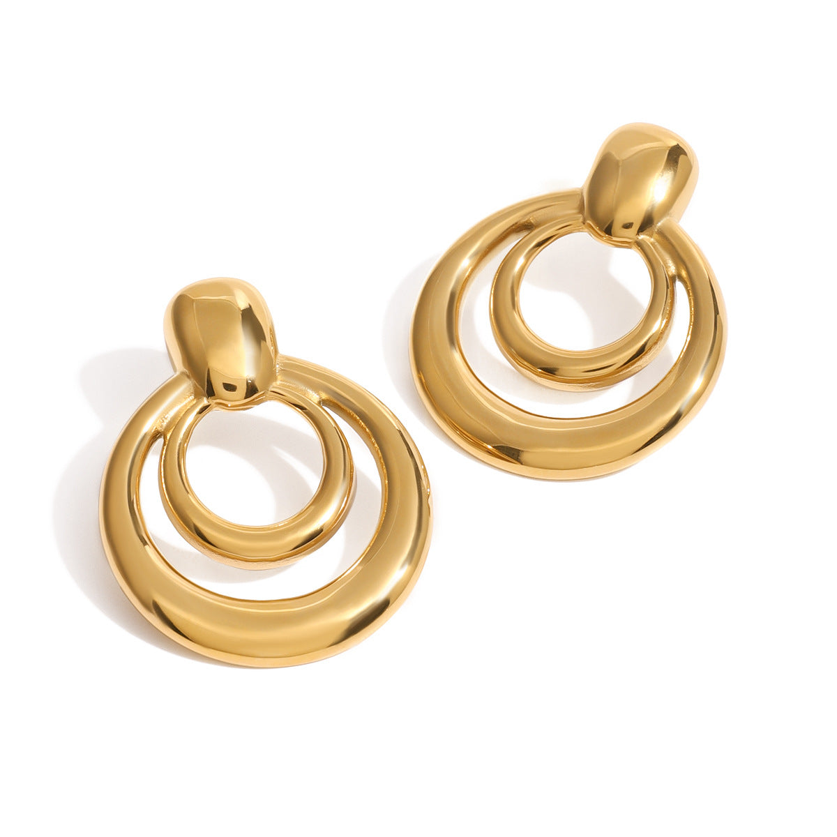 front view of gold plated nested hoop drop earrings on white background
