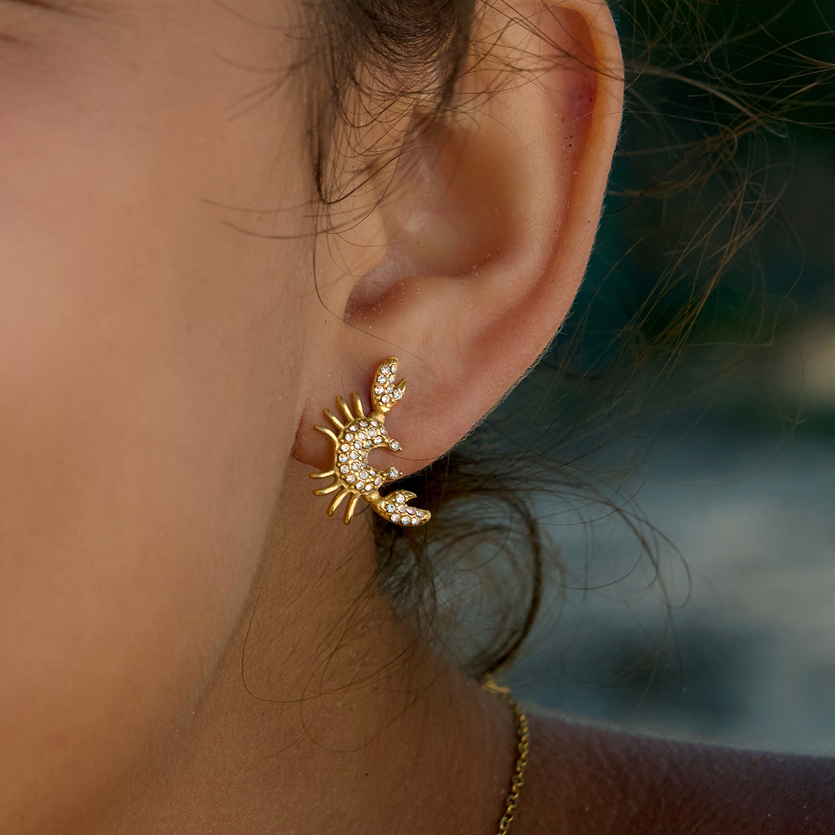 Clear-stone crab stud worn on an ear