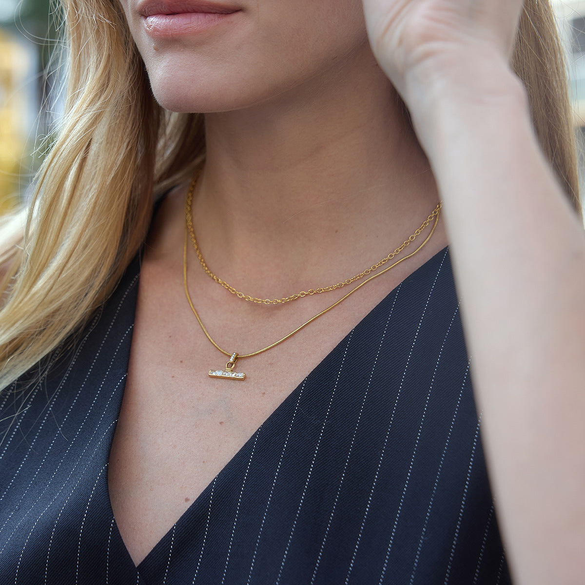 Clear-stone T-bar necklace shown on a model