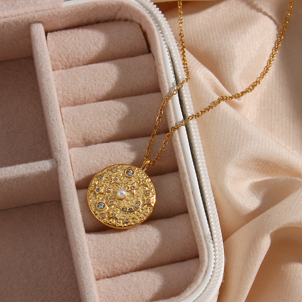 round textured coin pendant necklace displayed in a jewelry case