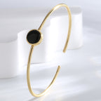 upright view of slim gold plated black agate open bangle
